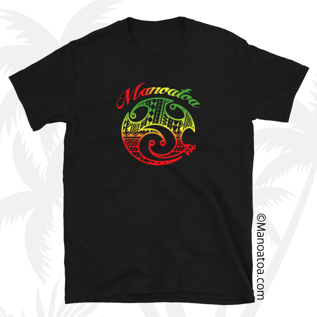 A casual T-shirt sporting the Manoatoa brand logo, featuring a Polynesian-style design. The colors are island reggae-inspired hues of red, yellow, and green, with the word "Manoatoa" prominently displayed above the logo.